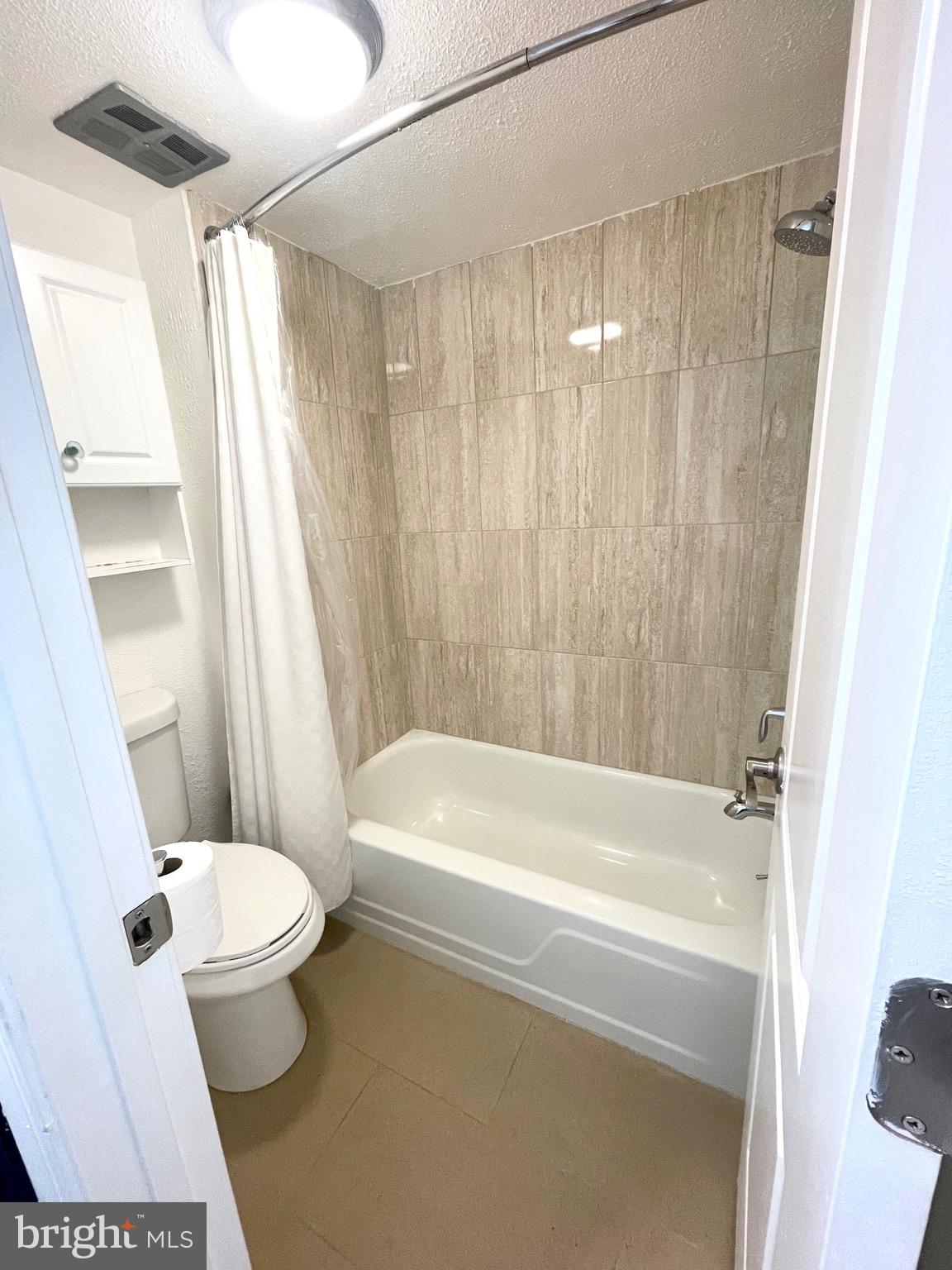 5234 West Running Brook Road, Unit 301 Columbia, MD 21044 - Photo 10 of 13 a white bath tub sitting next to a white toilet