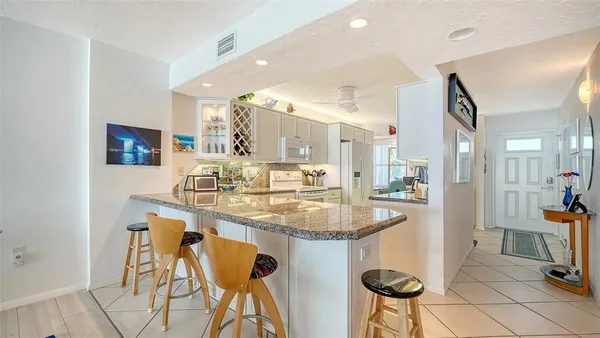 a spacious bedroom with a bed and a flat screen tv