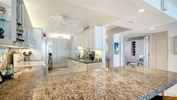a bathroom with a granite countertop sink a shower and a mirror