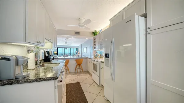 a spacious bathroom with a granite countertop sink a mirror a shower and a bathtub