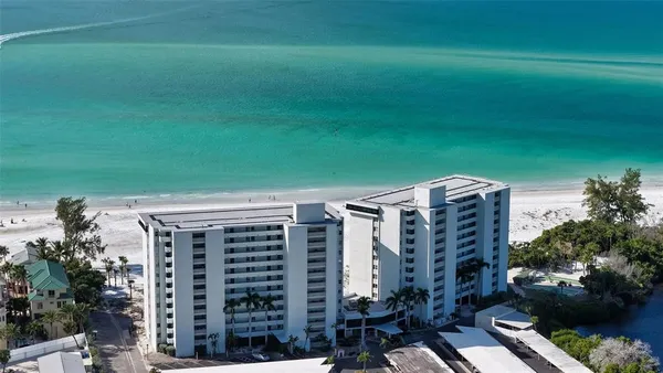 a view of a kitchen with furniture and a refrigerator