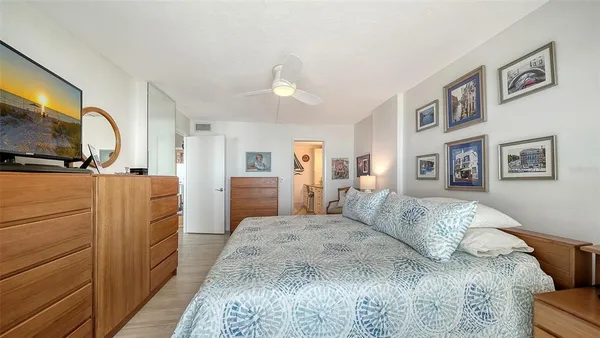 a view of a street with a flower plants and wooden fence