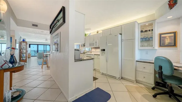 a dining room with furniture a chandelier and wooden floor
