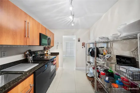 a kitchen with stainless steel appliances granite countertop a stove refrigerator and microwave