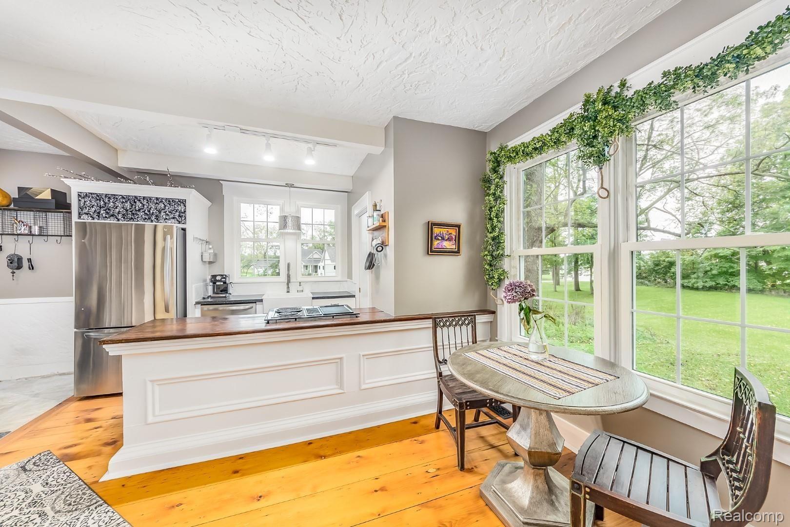 8480 Hyne Road Brighton, MI 48114 - Photo 11 of 50 Wood floor kitchen with distinctive trim & wainscoting