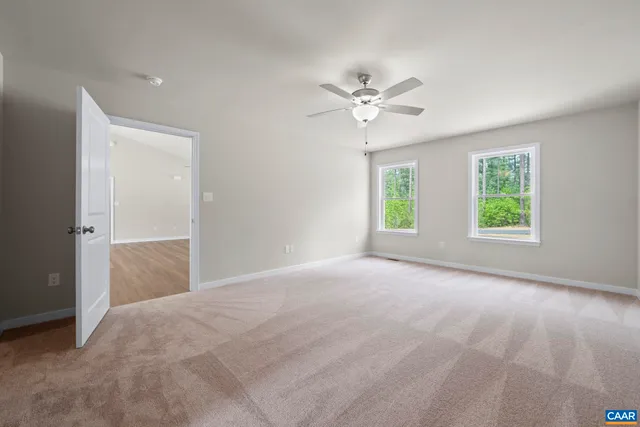 a bathroom with a granite countertop sink a toilet and a window