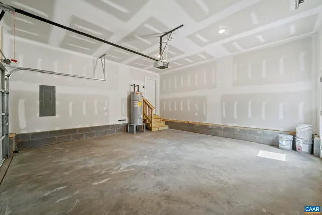 a front view of a house with a garden and trees