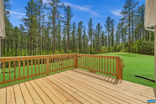 an aerial view of a residential houses with outdoor space and lake view
