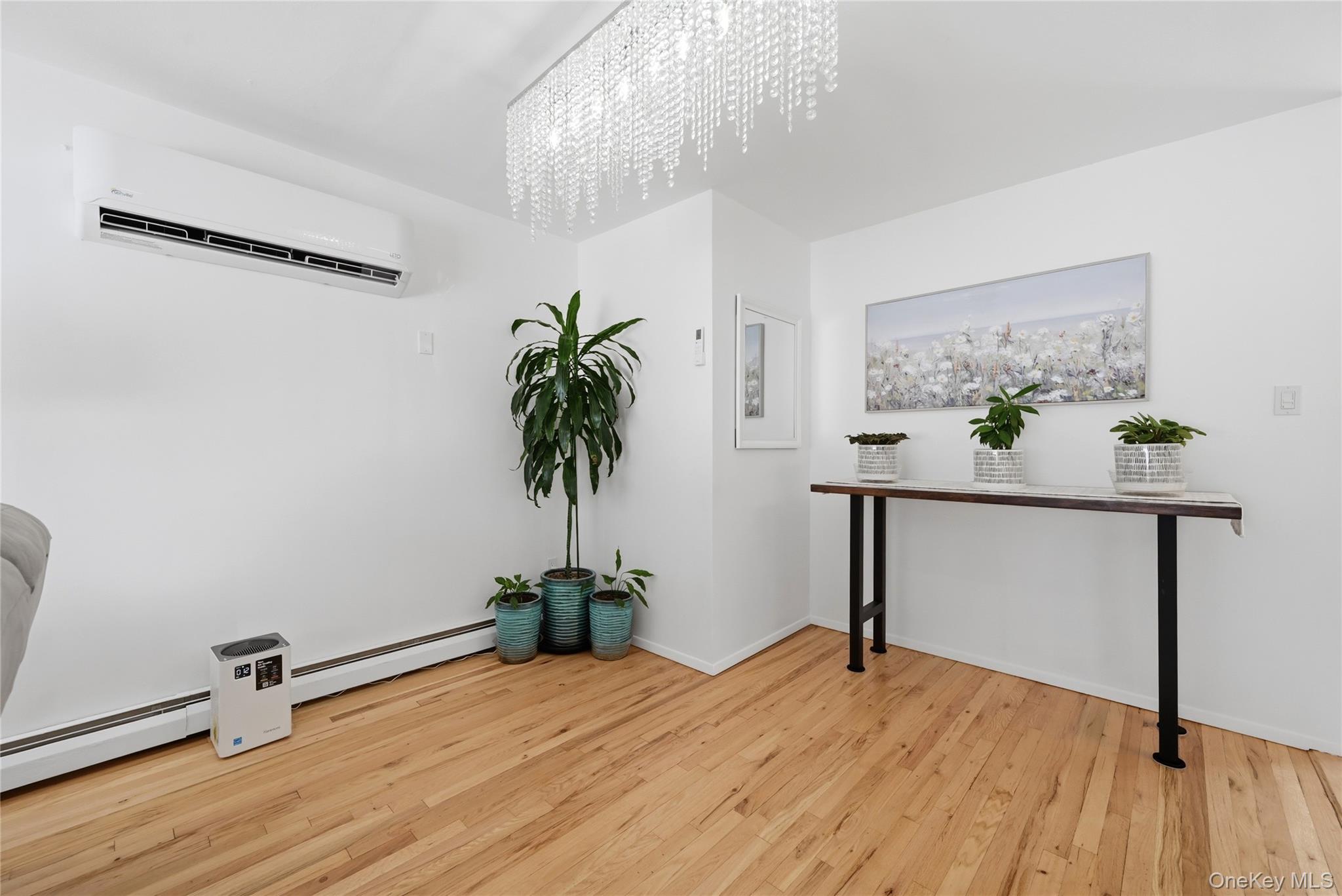 35 Randall Road Shoreham, NY 11786 - Photo 6 of 32 a view of a room with wooden floor and potted plant