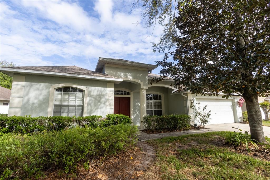 1812 Flower Branch Way Valrico, FL 33594 - Photo 1 of 42 a front view of a house with garden