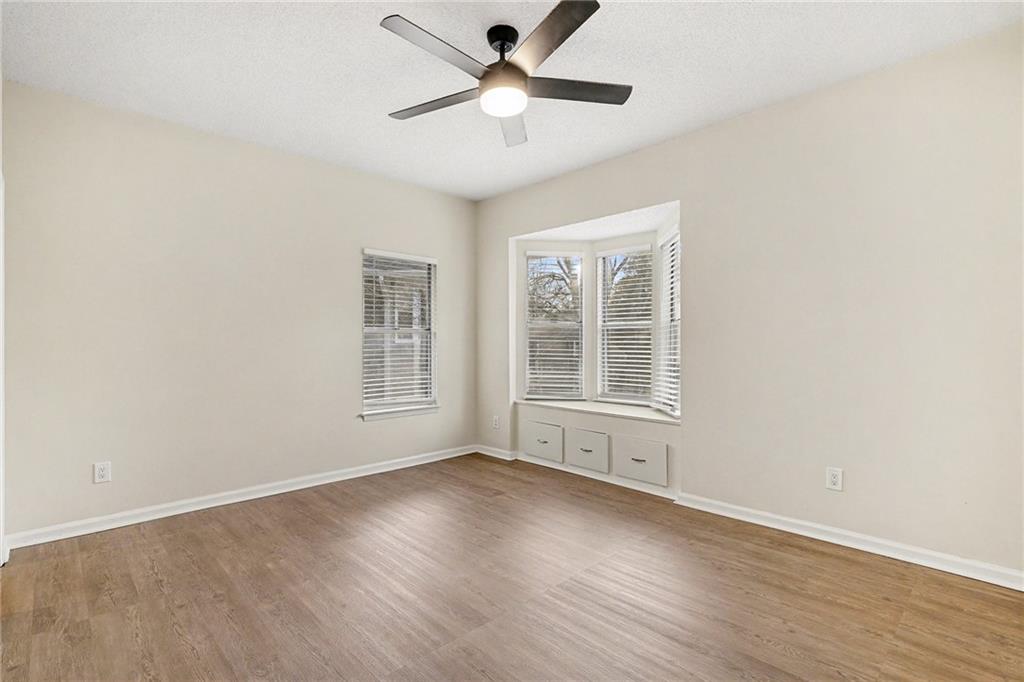 106 Ivy Green Lane Southeast Marietta, GA 30067 - Photo 11 of 20 a view of wooden floor and a chandelier fan in a room