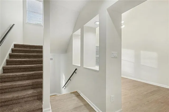 a view of entryway with wooden floor and stairs
