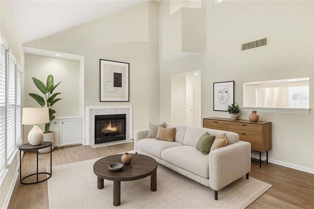 106 Ivy Green Lane Southeast Marietta, GA 30067 - Photo 4 of 20 a living room with furniture a fireplace and a potted plant