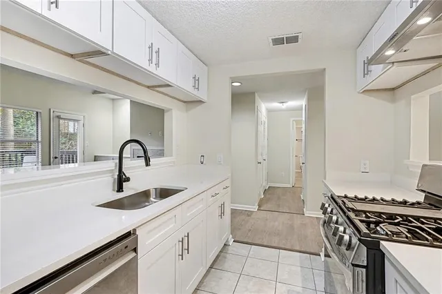 a kitchen with stainless steel appliances granite countertop a sink and cabinets