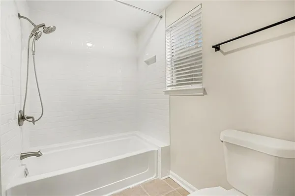 a bathroom with a bath tub with a shower