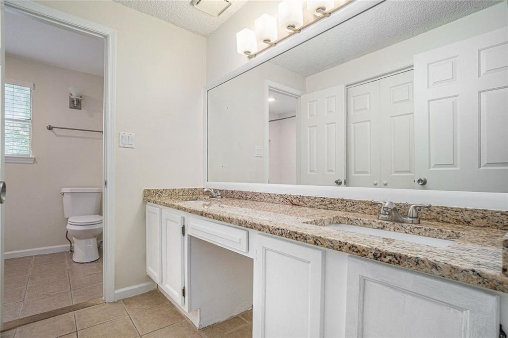 106 Ivy Green Lane Southeast Marietta, GA 30067 - Photo 8 of 20 a bathroom with a granite countertop sink and a toilet