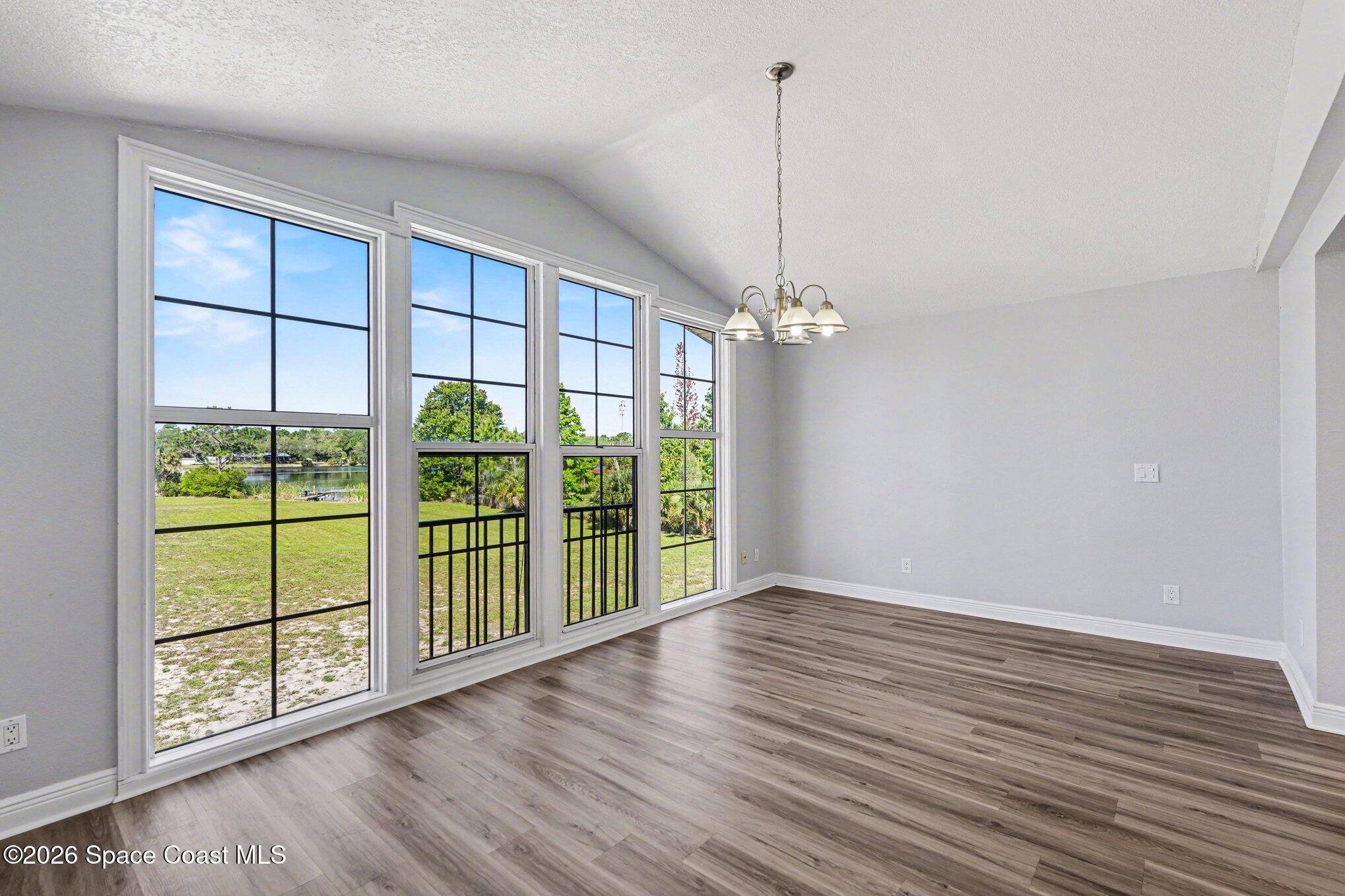 4950 Blounts Ridge Road Mims, FL 32754 - Photo 25 of 40 a view of an empty room with wooden floor and a window