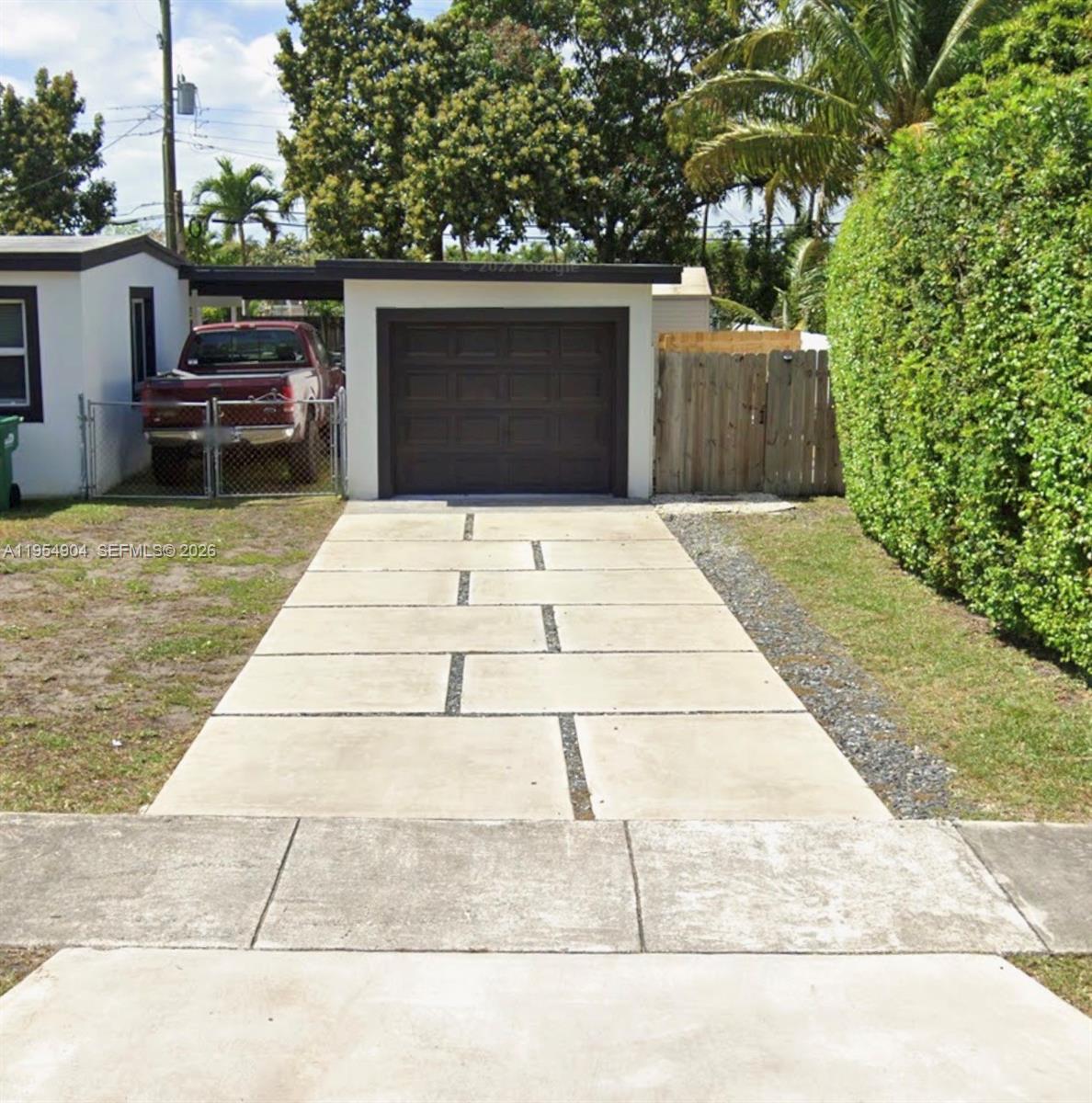 4910 Southwest 98th Avenue Road, Unit A Miami, FL 33165 - Photo 2 of 8 a front view of a house with a garden