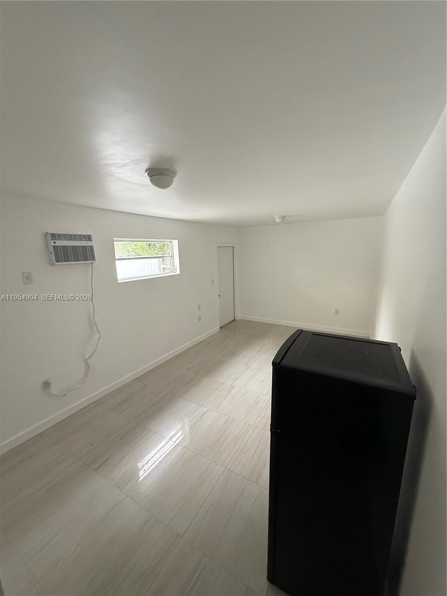 4910 Southwest 98th Avenue Road, Unit A Miami, FL 33165 - Photo 3 of 8 an empty room with windows