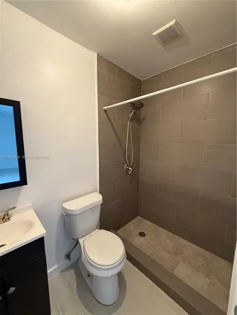 a bathroom with a toilet a sink and shower