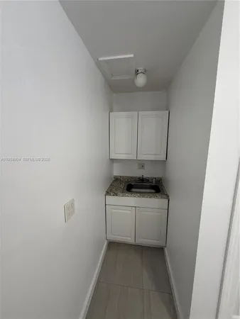 a stove top oven sitting inside of a kitchen