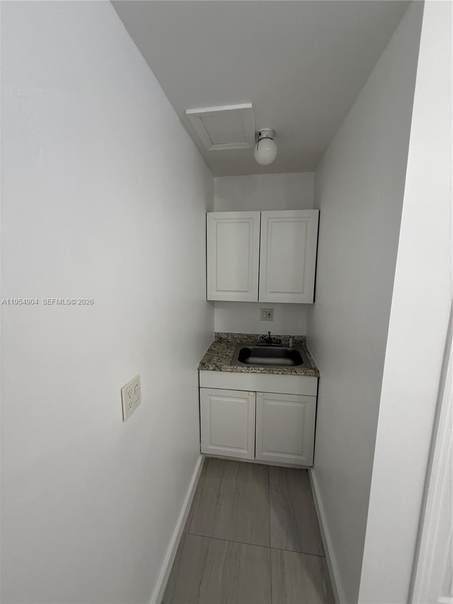 4910 Southwest 98th Avenue Road, Unit A Miami, FL 33165 - Photo 7 of 8 a stove top oven sitting inside of a kitchen