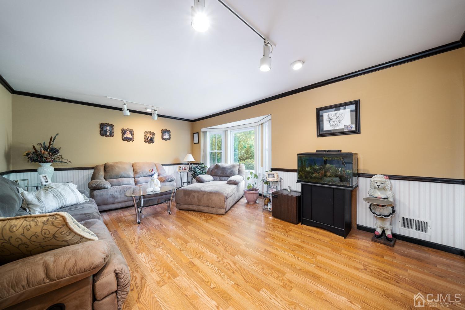 465 Cottrell Road Old Bridge, NJ 08857 - Photo 2 of 45 a living room with furniture and a flat screen tv