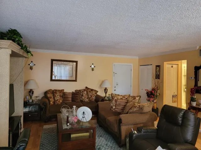 a living room with furniture a couch and a window