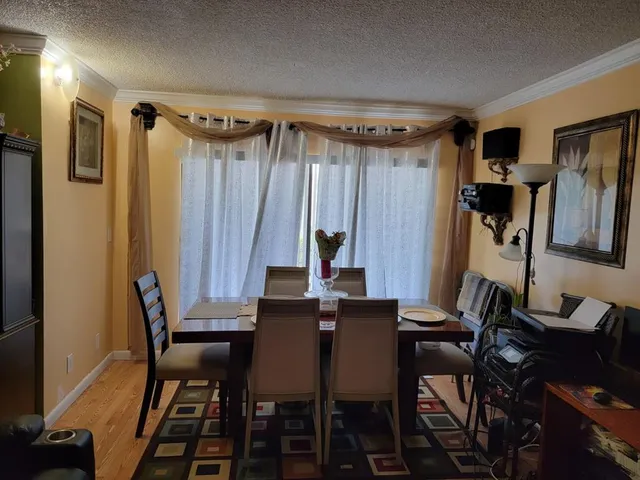 a view of a dining room with furniture and a chandelier