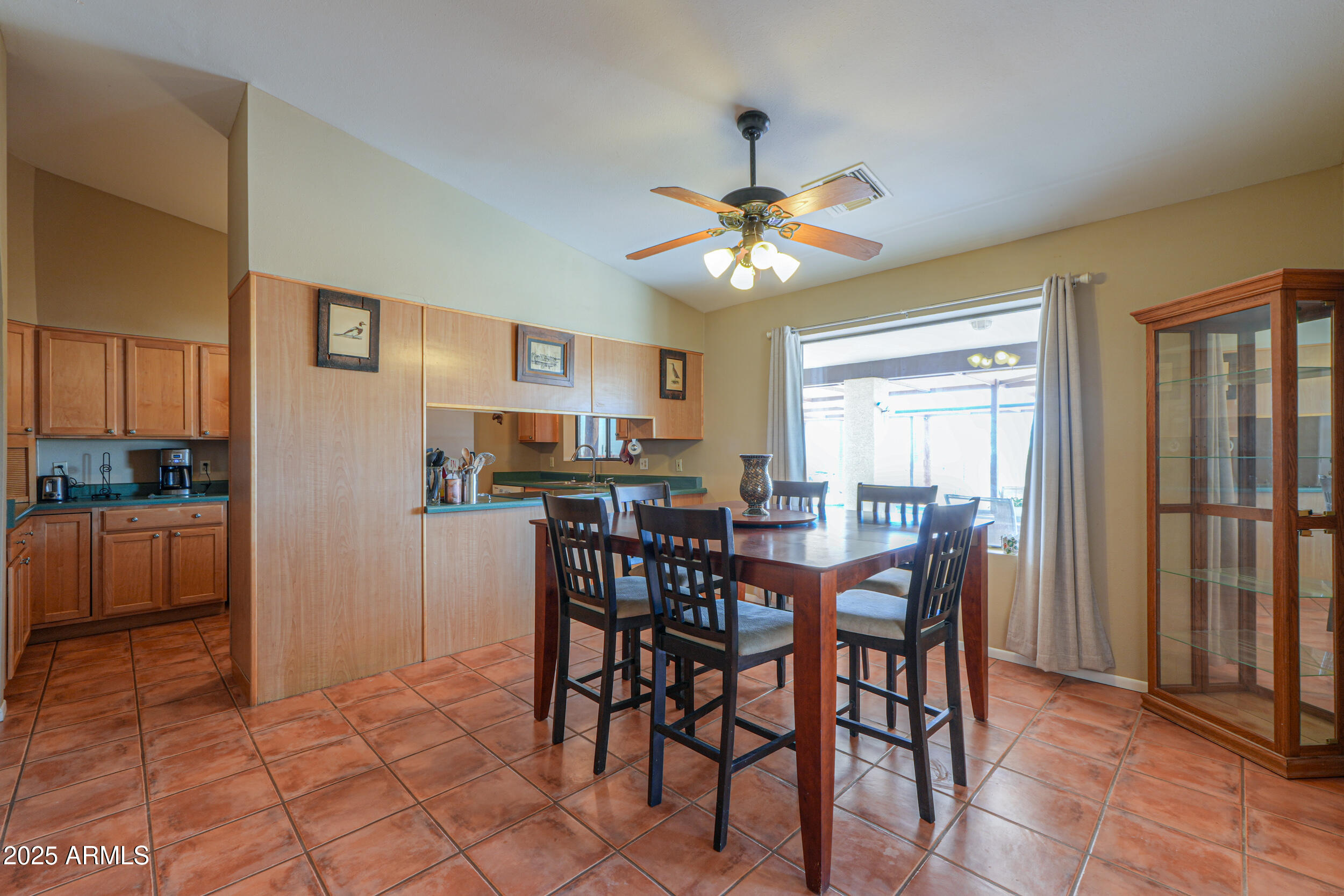 209 South Hidden Valley Road Maricopa, AZ 85139 - Photo 10 of 39 a view of a dining room with furniture and a chandelier
