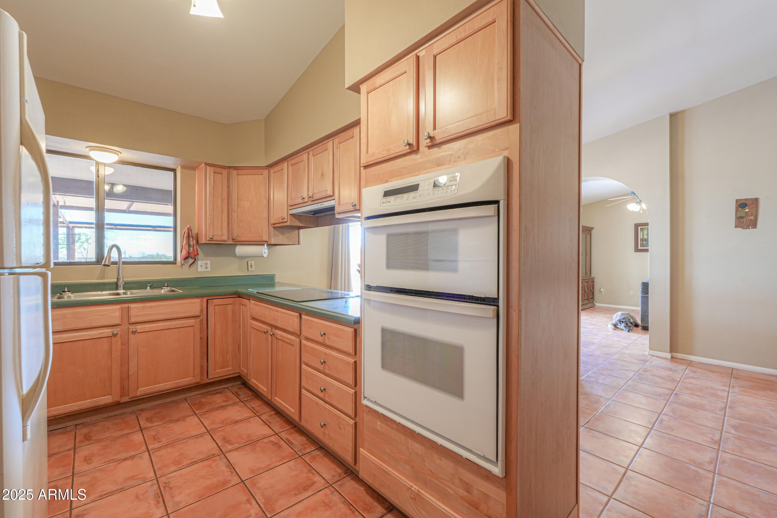 209 South Hidden Valley Road Maricopa, AZ 85139 - Photo 13 of 39 a kitchen with stainless steel appliances granite countertop a refrigerator and a sink