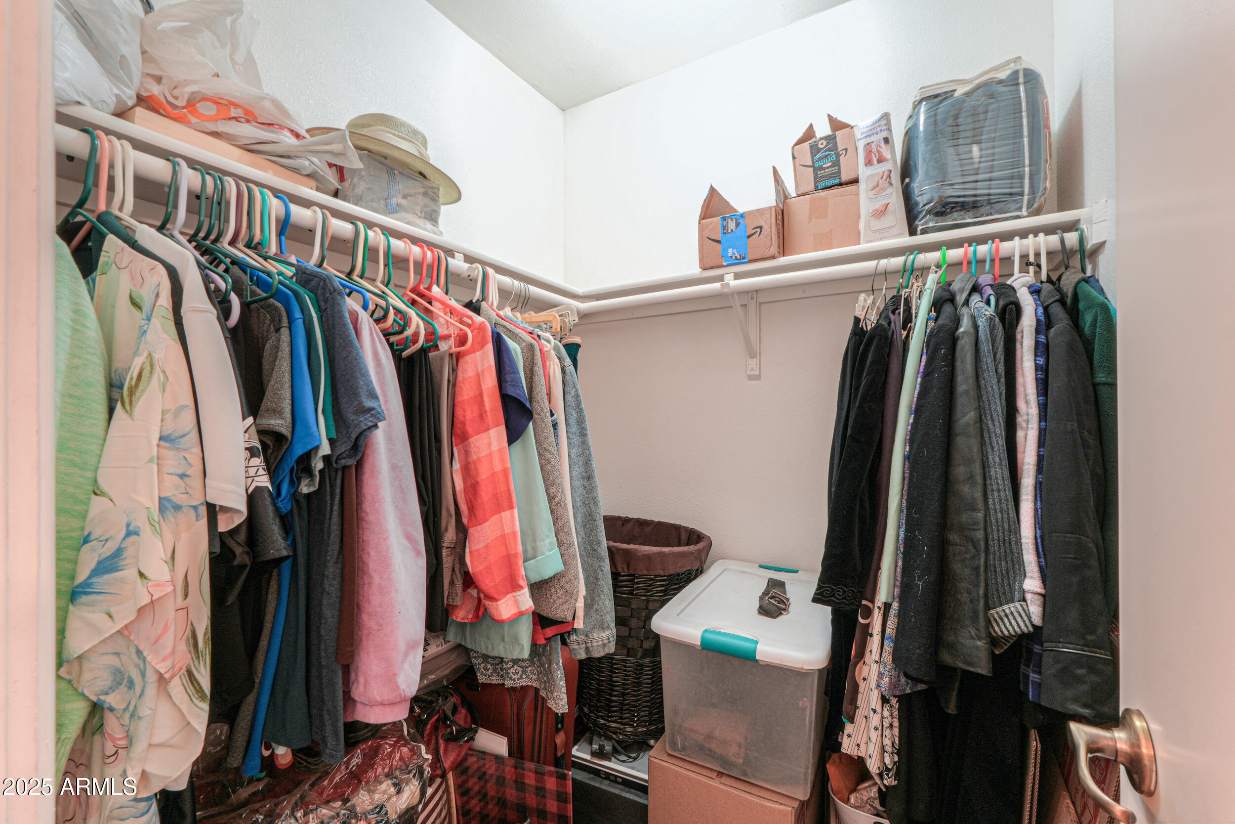 209 South Hidden Valley Road Maricopa, AZ 85139 - Photo 18 of 39 a view of walk in closet with clothes and shoes