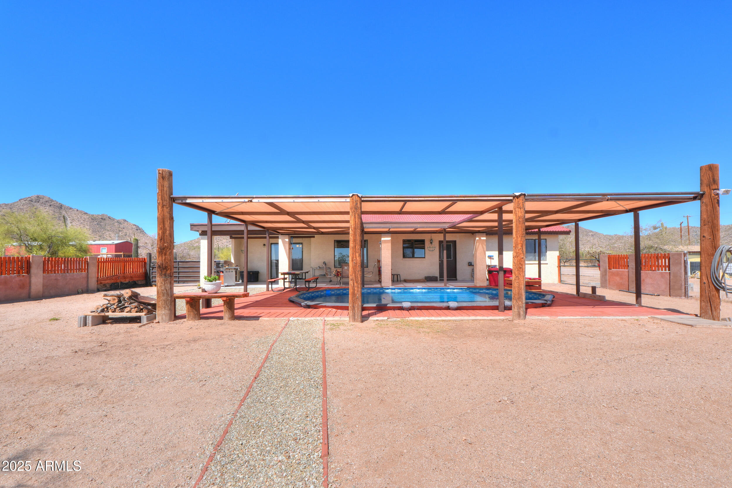 209 South Hidden Valley Road Maricopa, AZ 85139 - Photo 28 of 39 a view of a building with sitting area and roof