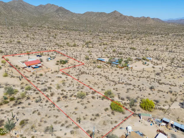 a view of a field with mountains in the background