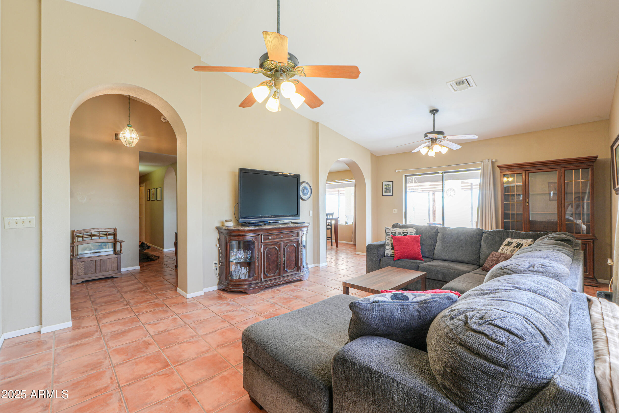 209 South Hidden Valley Road Maricopa, AZ 85139 - Photo 9 of 39 a living room with furniture and a flat screen tv