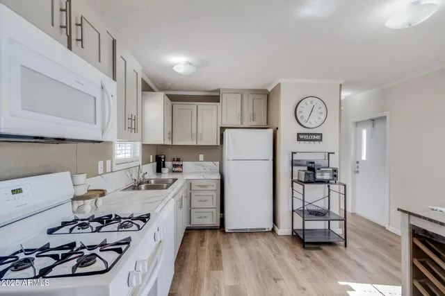 a kitchen with a refrigerator and a stove top oven