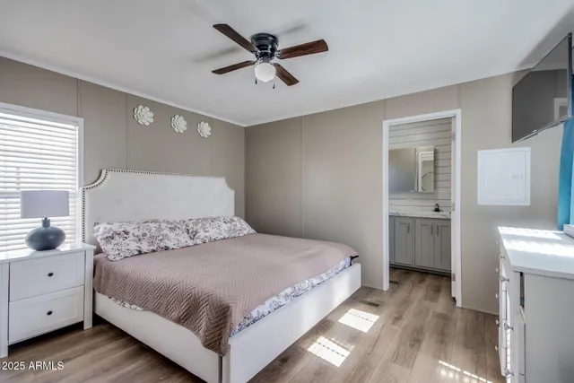 a bedroom with a bed and a chandelier