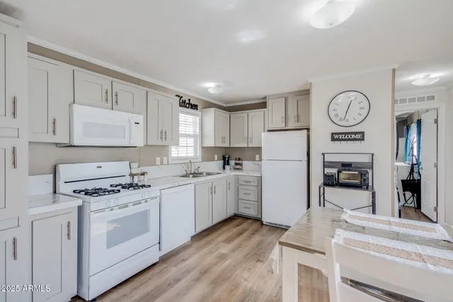 a kitchen with cabinets and stainless steel appliances