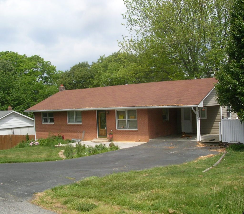 7699 Brandon Road Radford, VA 24141 - Photo 1 of 3 a front view of a house with a garden