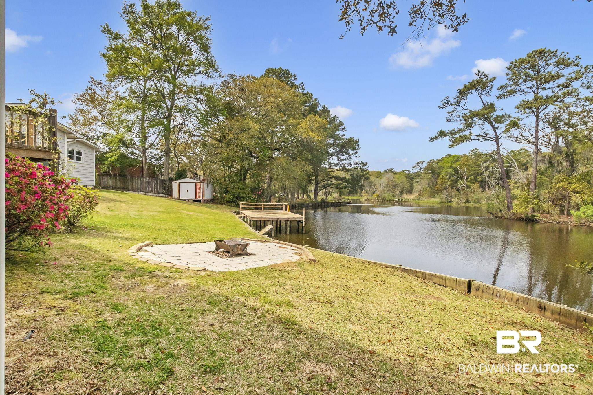 2901 Alston Court Mobile, AL 36605 - Photo 48 of 59 View of yard featuring a fire pit, a shed, fence, and a water view