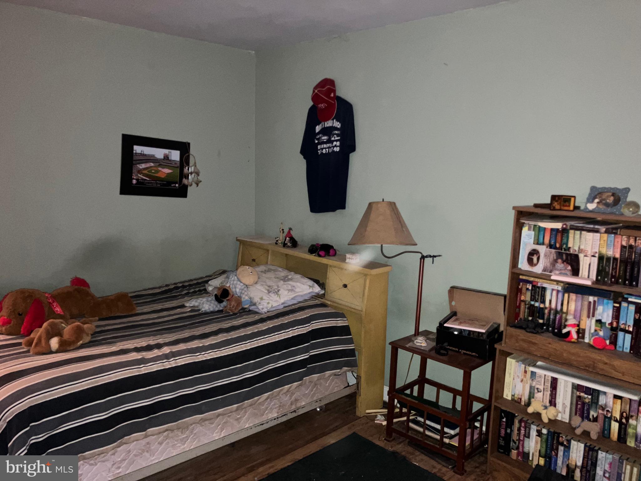 725 Marticville Road Pequea, PA 17565 - Photo 18 of 27 a bedroom with a bed and book shelf