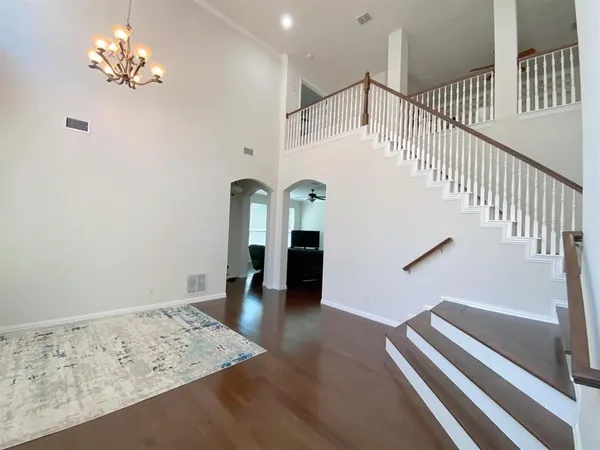 a view of entryway and hall with wooden floor
