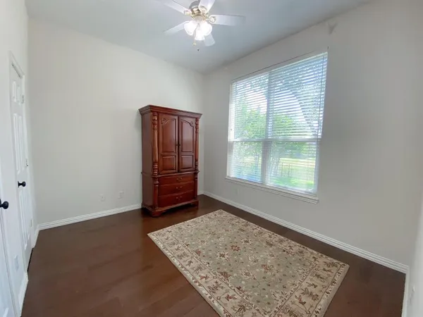 a living room with furniture a flat screen tv and a window