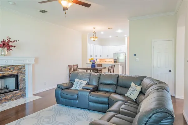 a living room with furniture a flat screen tv and a fireplace