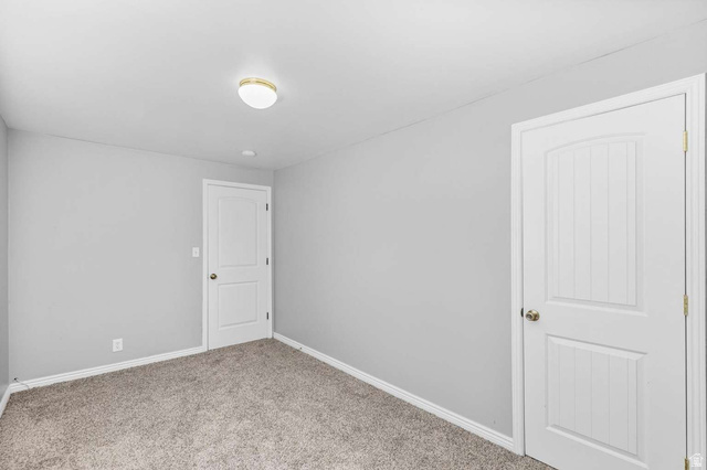415 East 1150th Street North Logan, UT 84341 - Photo 23 of 38 Carpeted room with light gray walls, white baseboards, and two white panel doors