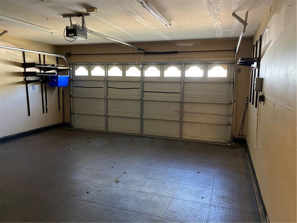 8007 Bounty Trail Austin, TX 78749 - Photo 31 of 32 Functional garage with practical storage and resilient flooring ready for vehicle or hobbies.