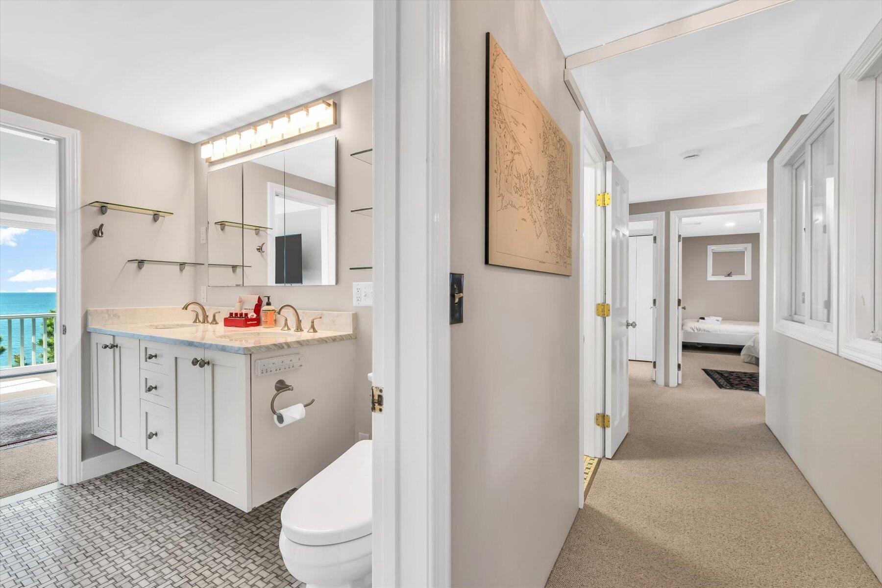 90 Ring Road Wellfleet, MA 02667 - Photo 35 of 86 a bathroom with a sink a toilet and a large mirror