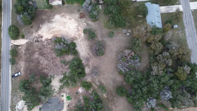 an aerial view of a house with yard