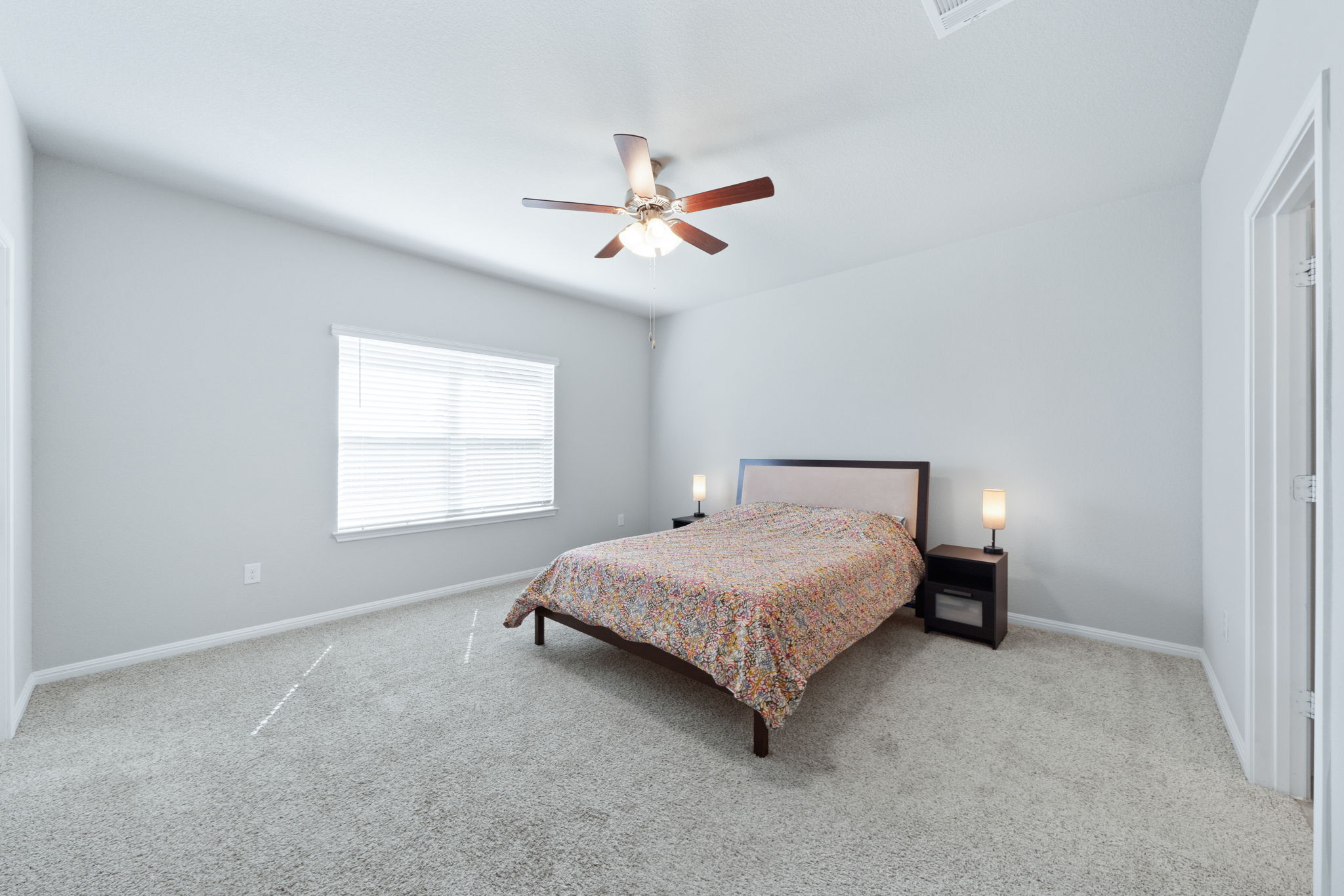 2412 Starhill Ranch Street Georgetown, TX 78628 - Photo 22 of 40 Well-lit sleeping quarters with plush carpeting and a versatile ceiling fan.