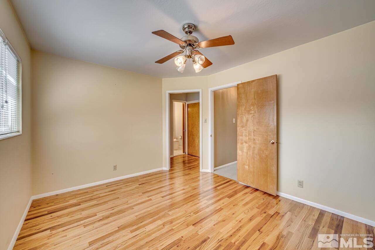 1950 Wren Street Reno, NV 89509 - Photo 13 of 24 a view of an empty room with wooden floor and a window